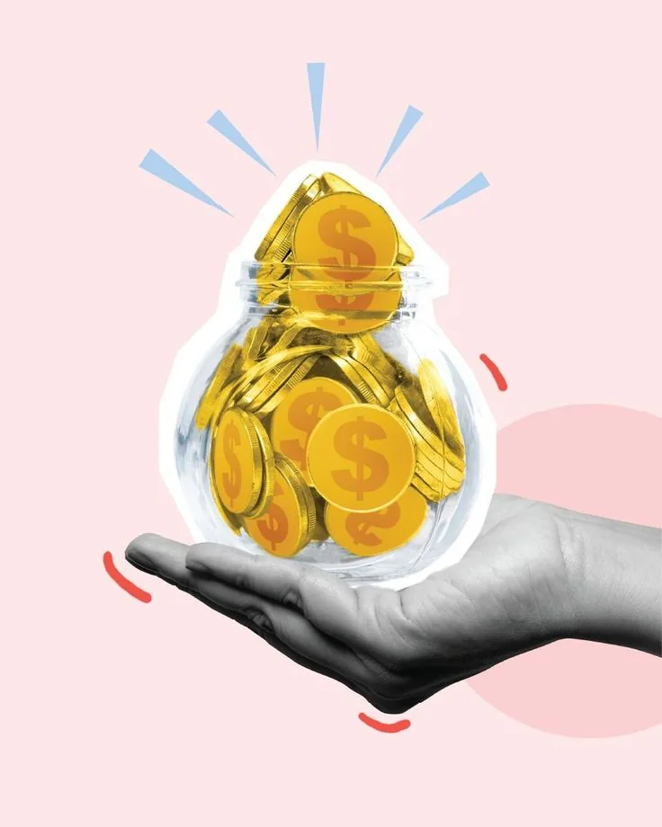 Hand holding a glass jar full of gold coins